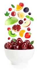 Falling fresh fruits and berries in bowl