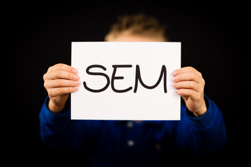Male holding SEM sign