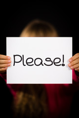 Child holding Please sign