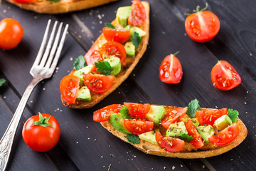 Bruschetta with tomato, avocado and herbs