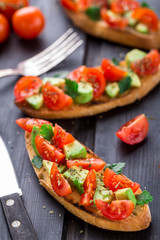 Bruschetta with tomato, avocado and herbs