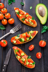 Bruschetta with tomato, avocado and herbs