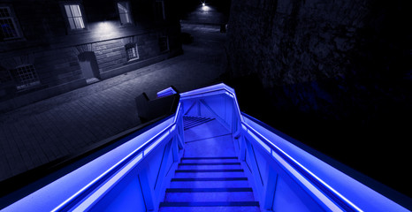 An illuminated staircase leads into the Royal William Yard.