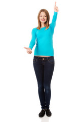 Fototapeta premium Woman showing thumbs up with both hands