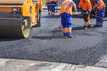 Roller and workers on asphalting and repair of city streets - 81456492