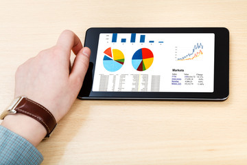 businessman hand hold tablet with business analytics