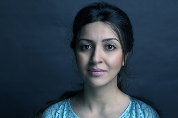 Beautiful trendy girl with fashionable makeup in a studio posing