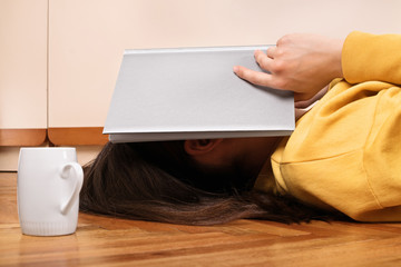 Girl with an open book over her head
