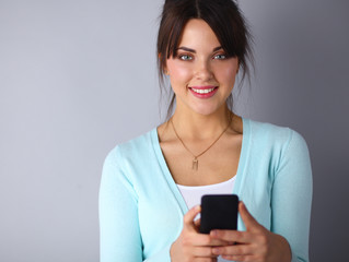 Fototapeta premium Woman using and reading a smart phone