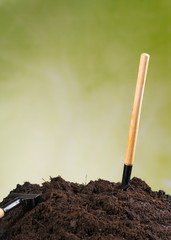 Pile of soil with green background