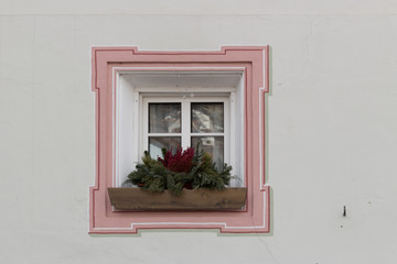 Obraz na płótnie Canvas Squared glass window with pink frame and simple border with plan