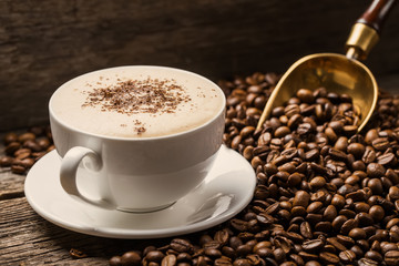 Close-up of coffee cup with roasted coffee beans