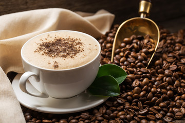 Close-up of coffee cup with roasted coffee beans