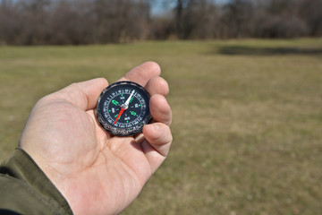 Compass in the hand on a walk.