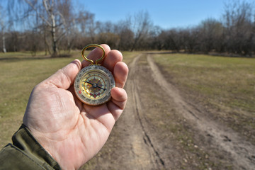Compass in the hand on a walk.