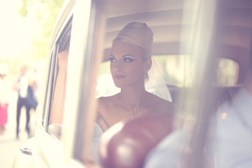 Beautiful bride waiting in the car