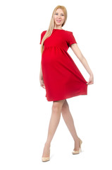 Fototapeta premium Pretty pregnant woman in red dress isolated on white