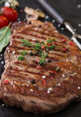 Beef rump steak on black stone table