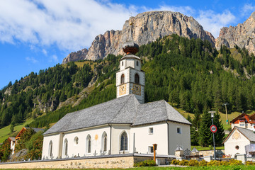 Church in Colfosco alpine village, Dolomites Mountains, Italy
