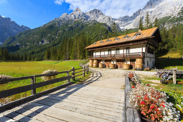 Fototapeta na wymiar Stable in green alpine valley in Dolomites Mountains, Italy
