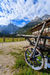 Fototapeta premium Wooden cart in Dolomites Mountains in summer, Italy