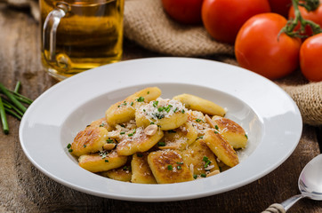 Homemade potato gnocchi with nuts and parmesan