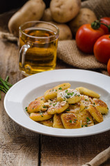 Homemade potato gnocchi with nuts and parmesan