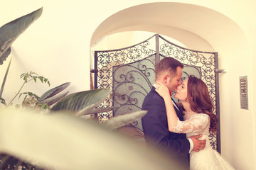 Bridal couple in front of vintage gate