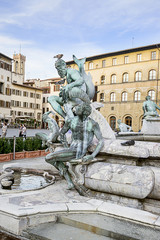 Fototapeta na wymiar Fountain of Neptune near the Old Palace (Palazzo Vecchio) on Squ