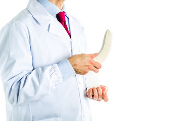 Doctor in white coat bandaging a banana