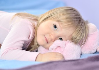 Little girl resting in bed.