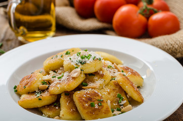 Homemade potato gnocchi with nuts and parmesan