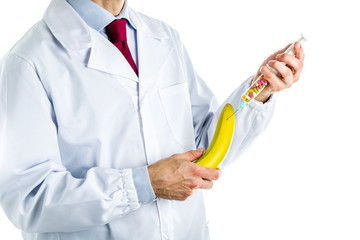 Doctor in white coat making an injection to a banana