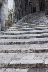 Fototapeta na wymiar Stone stairway in old Taranto, Italy.