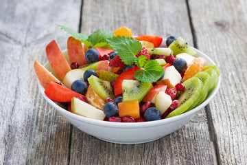 Fruit and berry salad on wooden table
