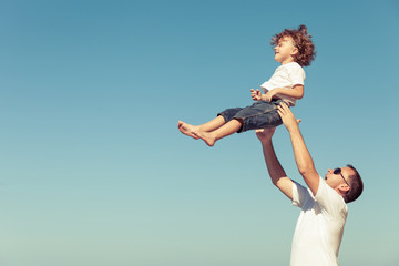 Obraz premium Father and son playing on the beach at the day time.