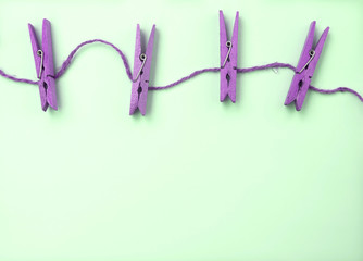 Purple wooden clothes pin on green background retro tone style