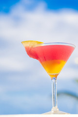 glass of fruit cocktail  on table near the beach