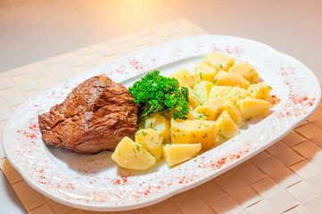 boiled potatoes and roast beef served beautifully