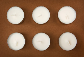 Six candles on the brown background