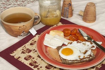 homemade breakfast, bread with butter, egg and cherry tomatoes