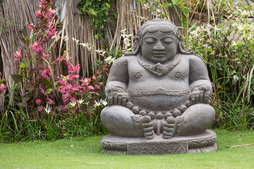 Traditional stone sculpture in garden . Bali, Ubud, Indonesia