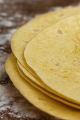 stack of tortillas on a wooden background