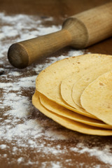 stack of tortillas on a wooden background