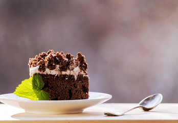 Delicious chocolate cake on plate on table