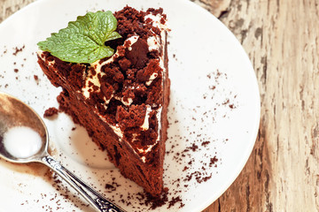 Delicious chocolate cake on plate on table