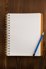 checked notebook on wood