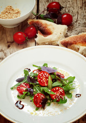 salad with tomatoes, arugula and sesame