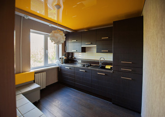 Beautiful designer kitchen in brown and yellow colors