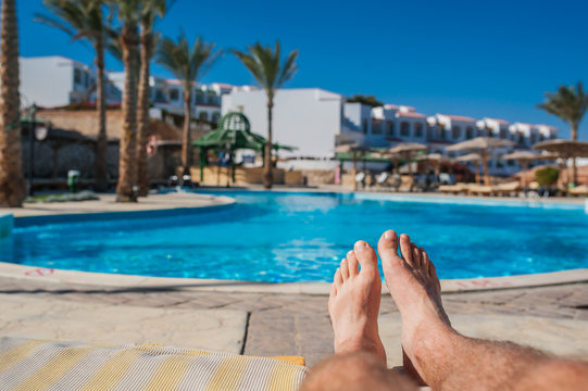 Man's feet on the background of a swimming pool